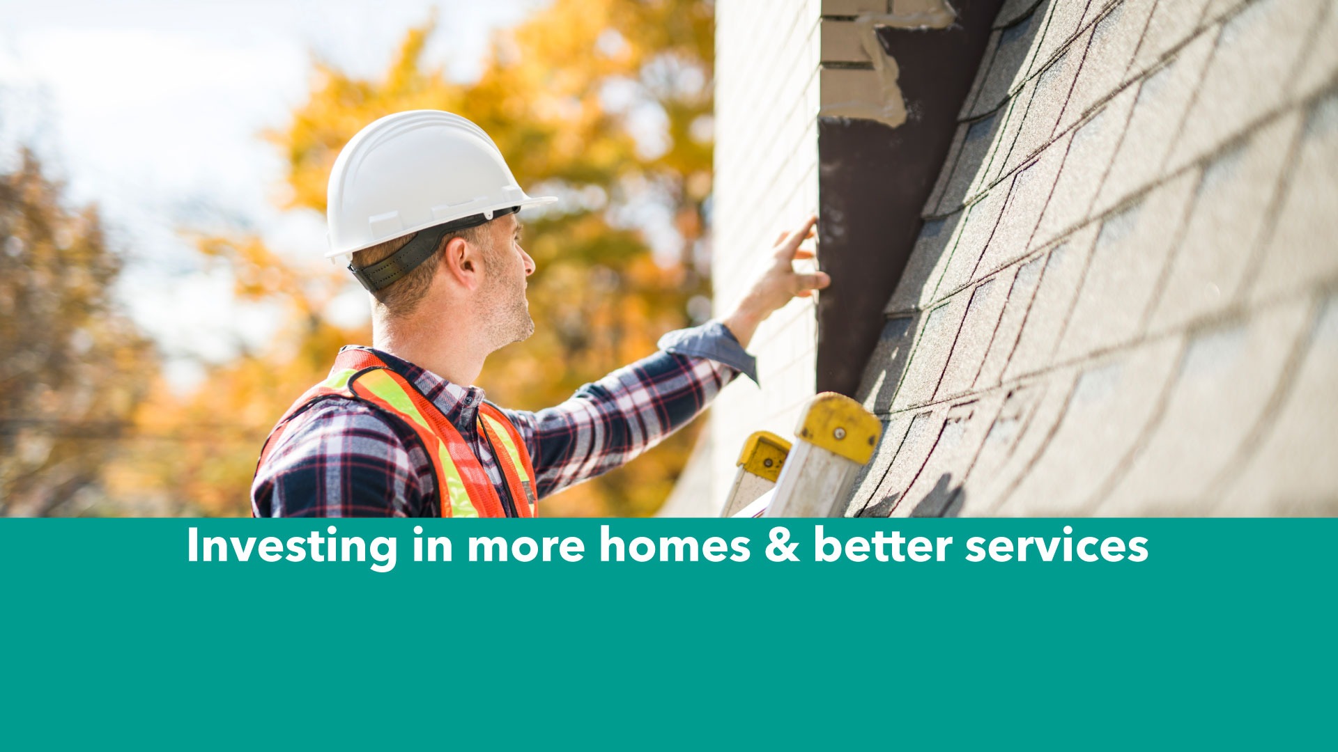A man up a ladder inspecting the roof of a house